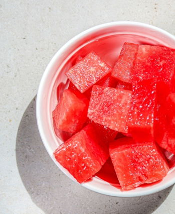 a-bowl-of-watermelon-cubes-on-a-table.jpg A bowl of watermelon cubes on a table